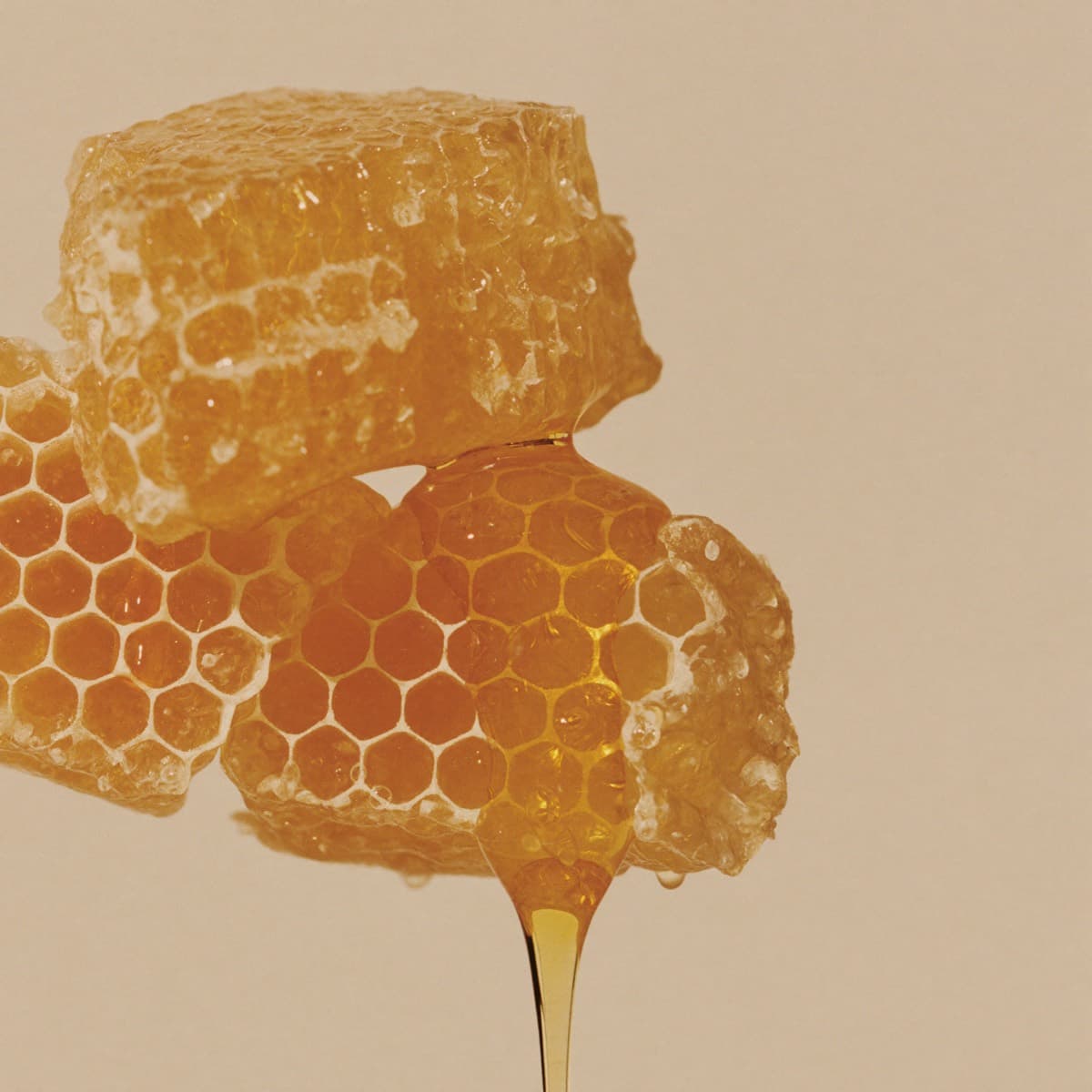 Golden honeycomb with dripping honey